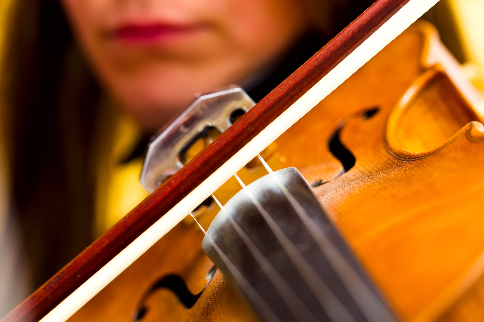 Girl playing the violin classical music concert