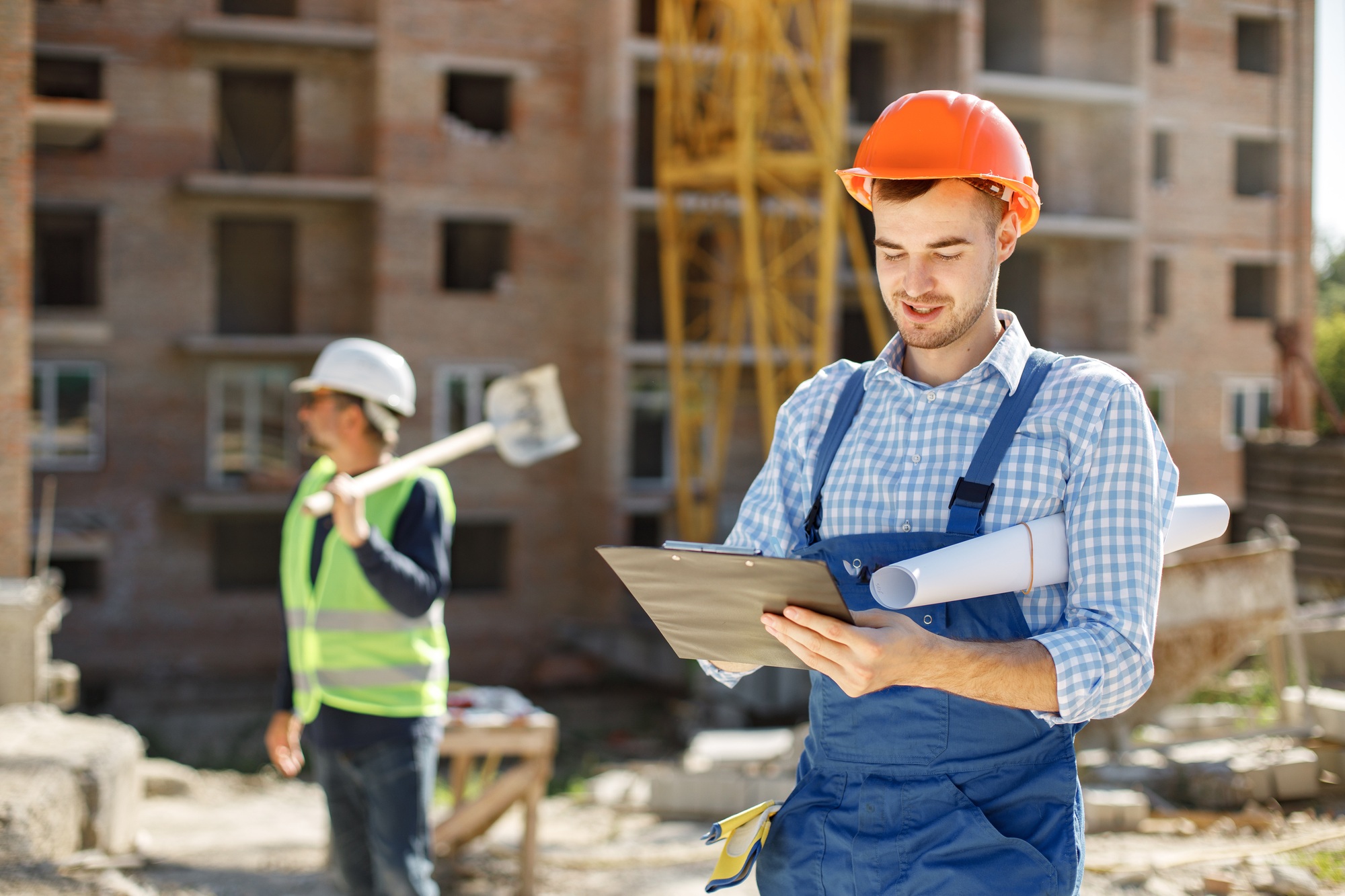 Two men engineers at a construction site doing their job