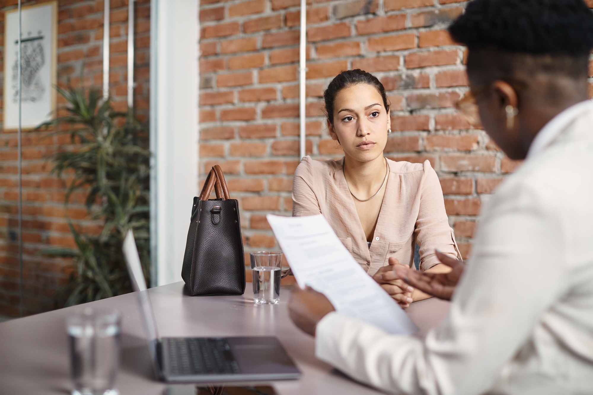 Young woman having job interview at corporate office.